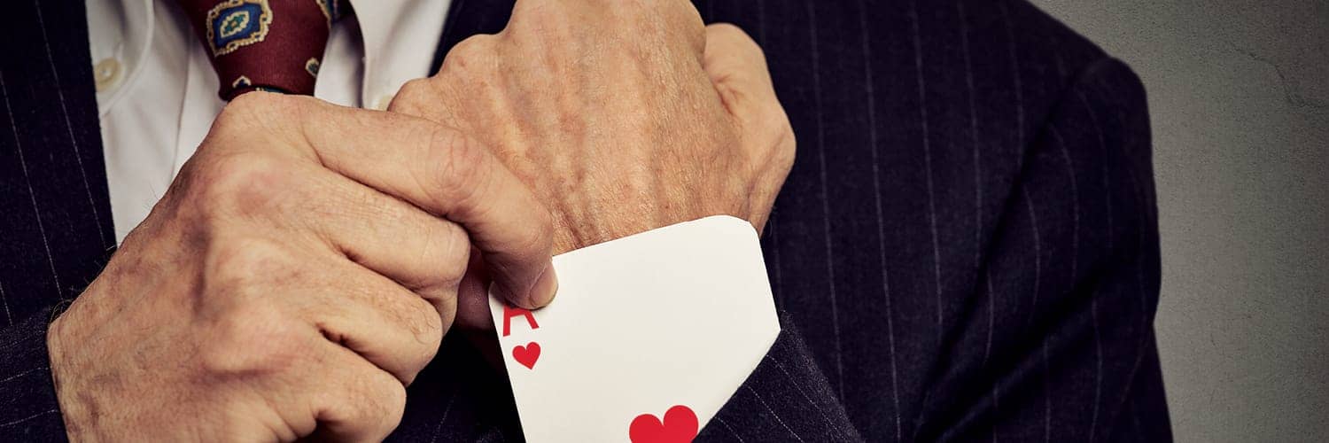 enhance customer experience - a man pulling an ace of hearts out of his sleeve